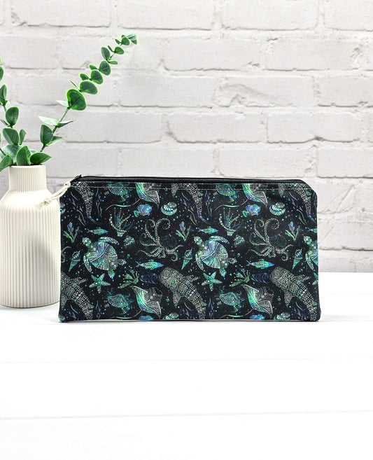 Flache, rechteckige Zip Pouch Runa aus schwarzem Stoff mit leuchtend grün-blauen Meerestieren, handgenäht in Bayern von Nadelmikado