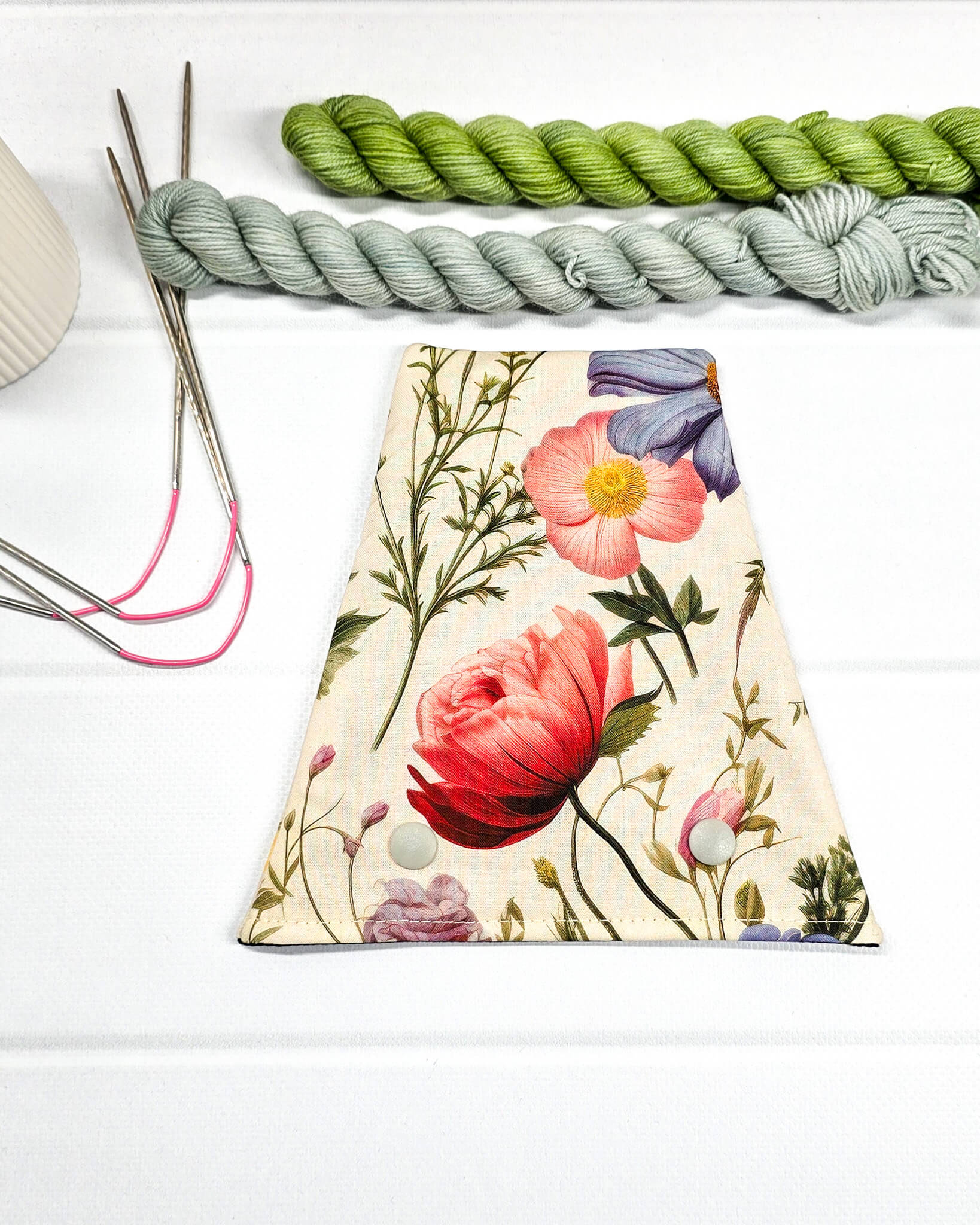 Nadelgarage für Trios aus beigefarbenem Stoff mit großen roten Pfingstrosen, lila Blüten und zwei hellen Druckknöpfen. Handgenäht in Bayern von Nadelmikado. 