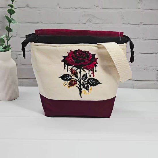 Projekttasche Tuva S aus hellem Canvas und Bordeaux mit gestickter Gothic Rose und schwarzem Kordelzugkragen. Handgenäht in Bayern von Nadelmikado.
