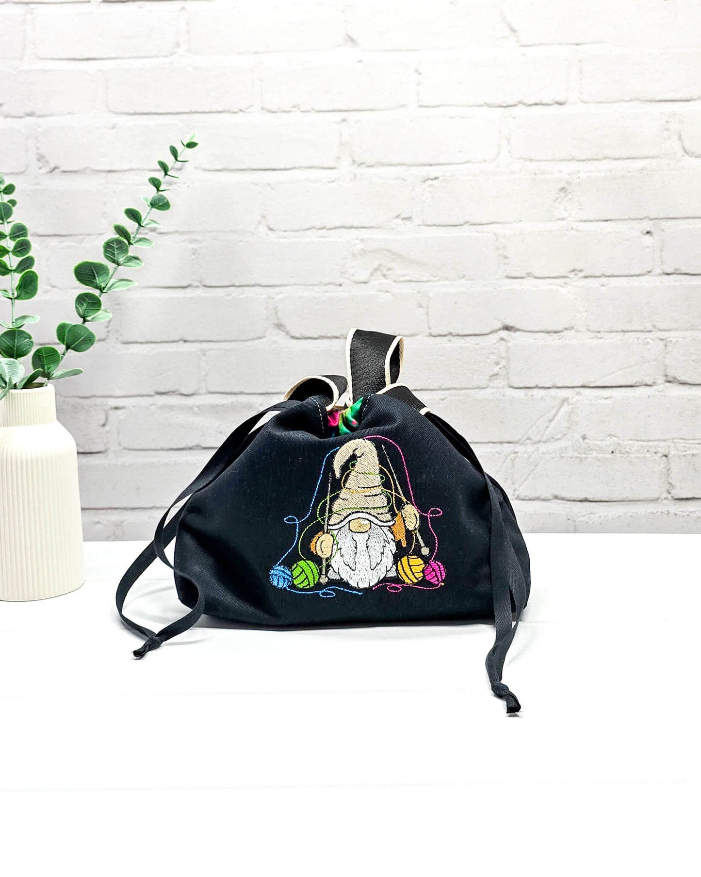 Projekttasche Alva S mit farbigem Strickwichtel auf schwarzem Stoff, handgenäht in Bayern von Nadelmikado