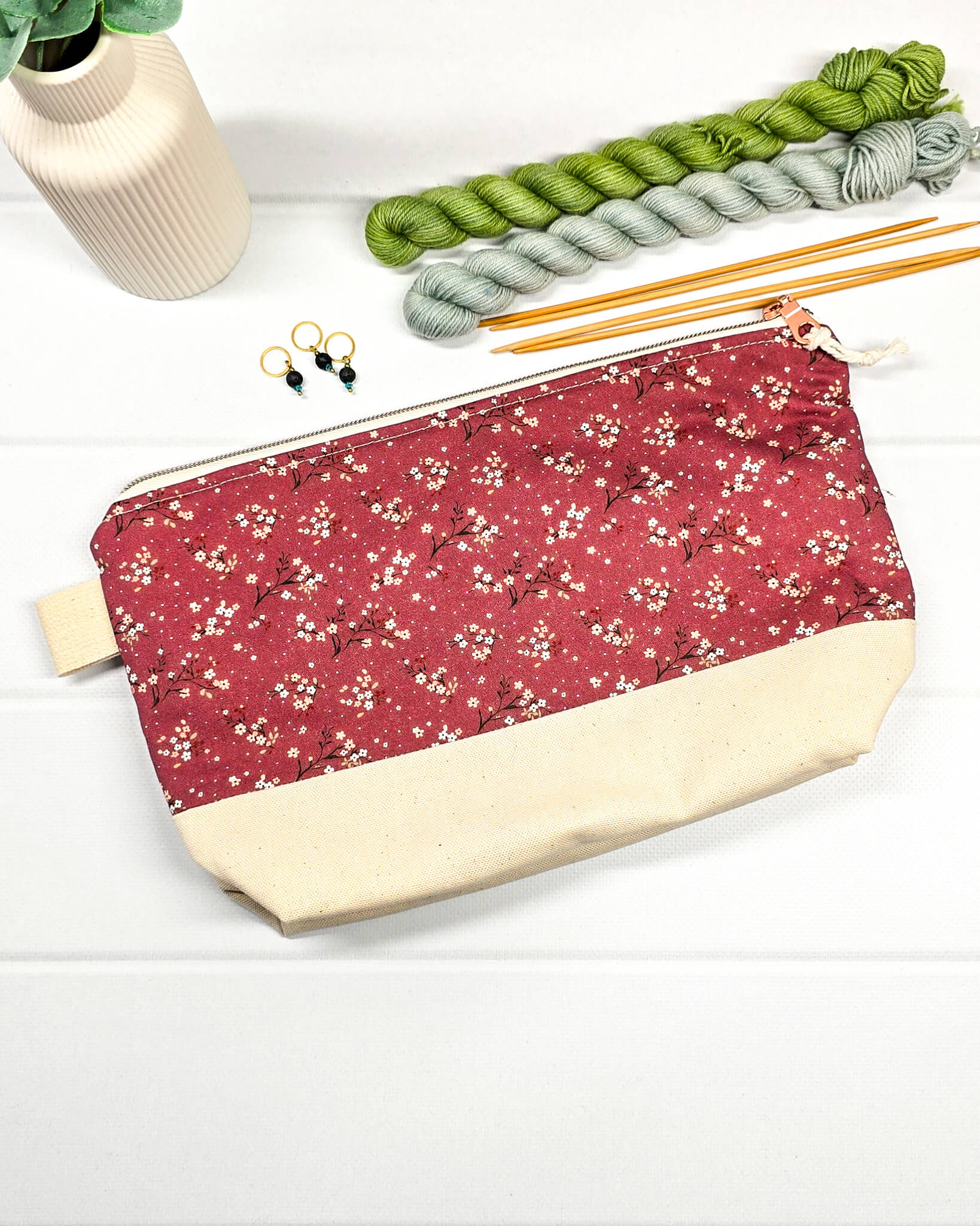 Stricktasche mit beerefarbenem Streublumen-Muster, hellem Canvas-Boden und Reißverschluss. Platz für 200g Wolle. Handgenäht in Bayern von Nadelmikado.