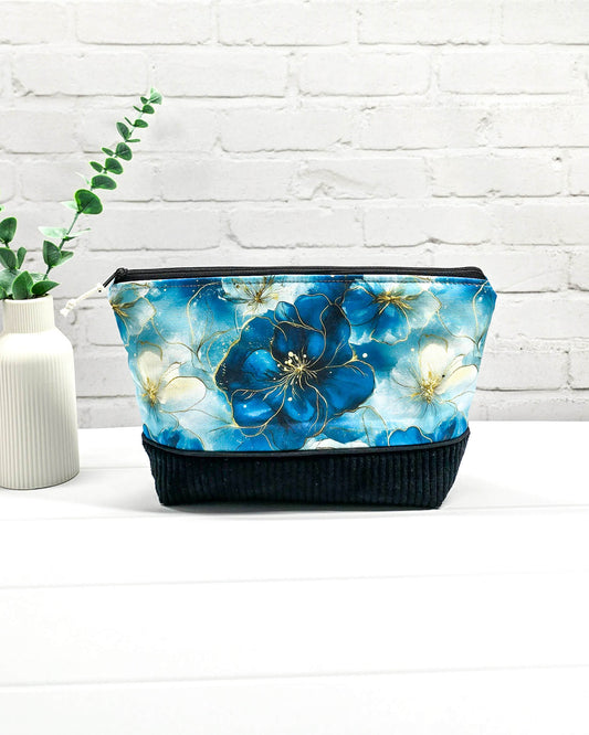 Handgemachte Projekttasche Isvind in Größe S mit blauen Aquarellblüten und einem Taschenboden aus schwarzem Breitcord. Handgenäht in Bayern von Nadelmikado. 