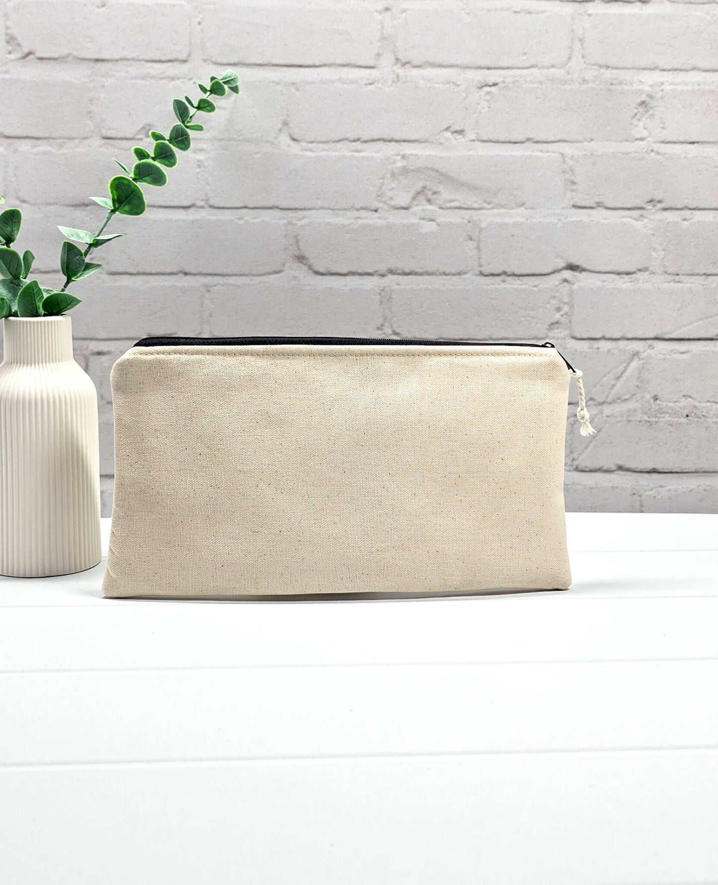 Flache, rechteckige Zip Pouch Runa aus beigem Canvas mit einem großen, blau-gold gestickten Schiffsanker, ideal um Stricknadeln, Seile und Scheren sicher zu verwahren. Handgenäht in Bayern von Nadelmikado